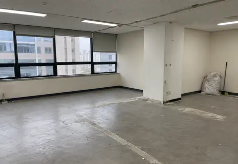 사무실 바닥과 천장 일부가 정리된 빈 업무 공간
